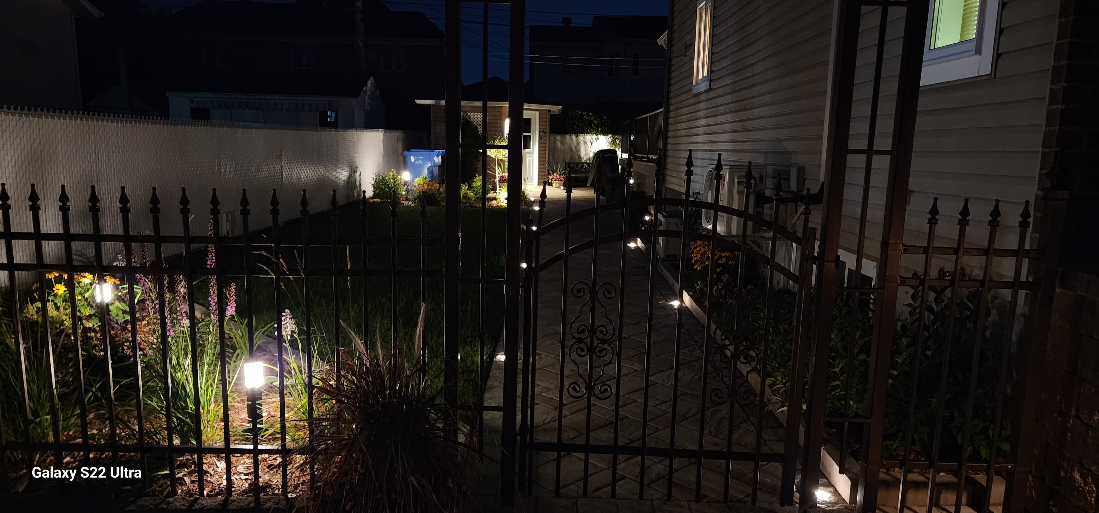 LED landscape lighting along paver walkway at night